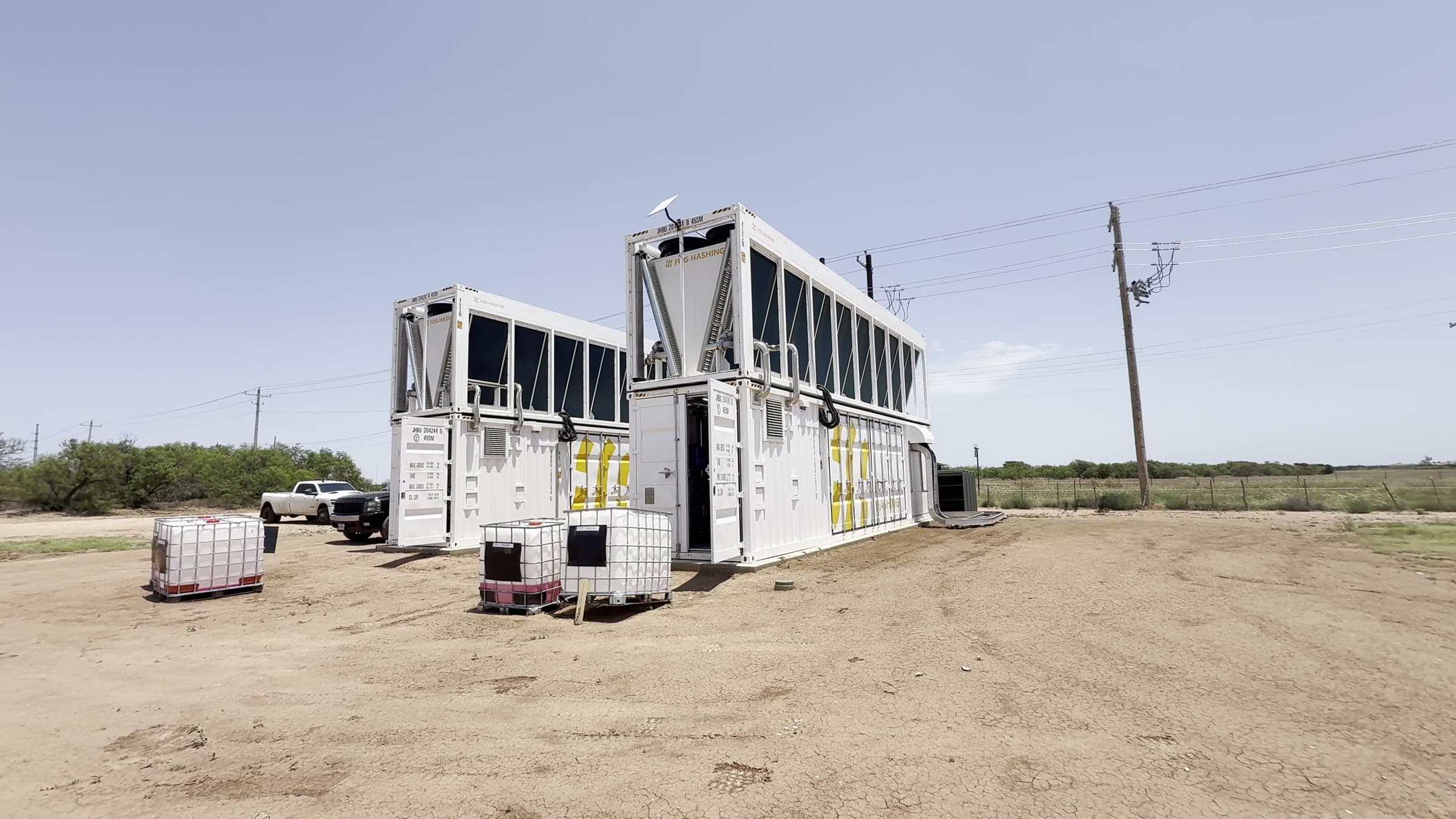 Exterior hydro mining containers and coolant tanks at the Fort Worth Hydro Mining Site.